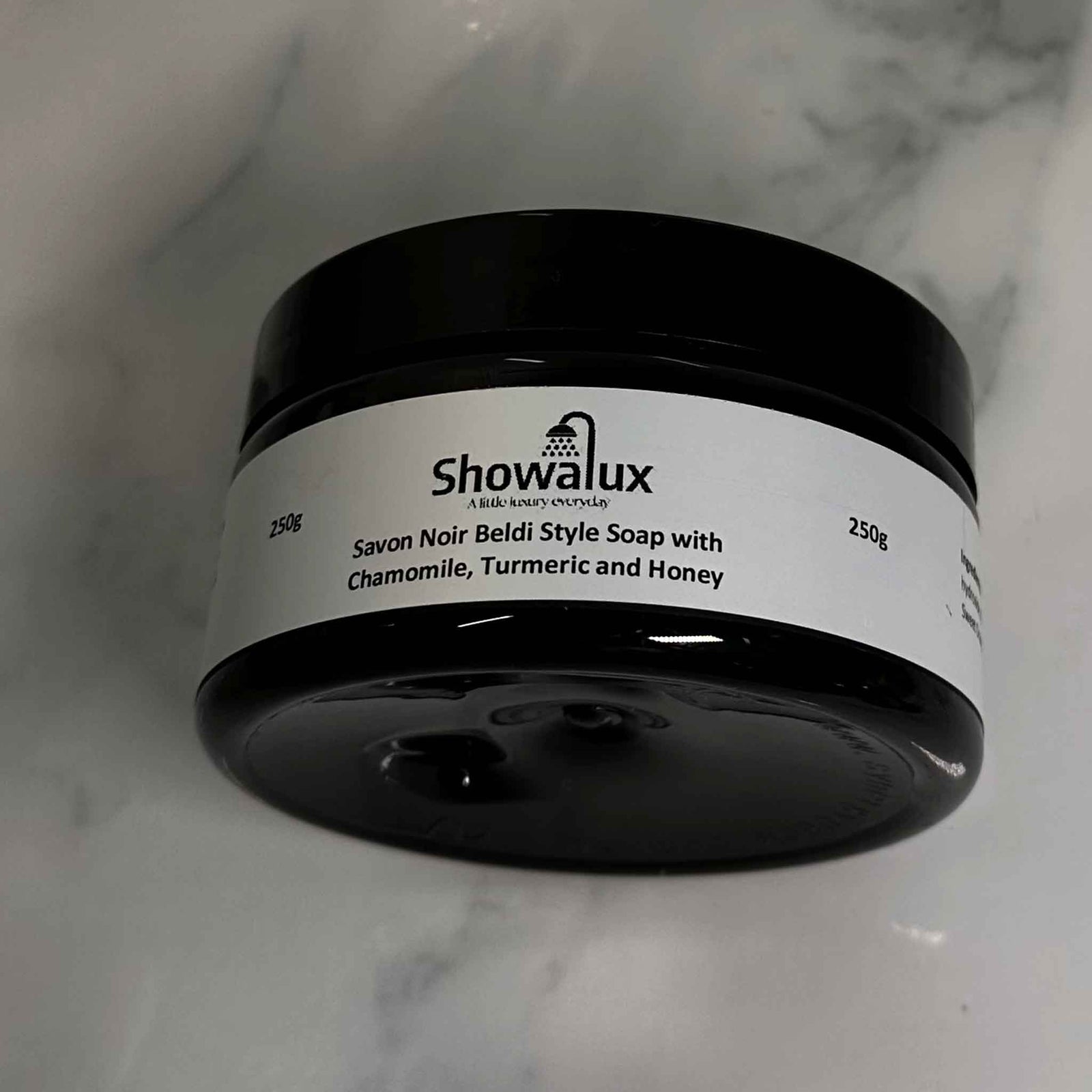 Side view of Beldi Soap with Chamomile Turmeric and Honey in a jar displaying the name and weight