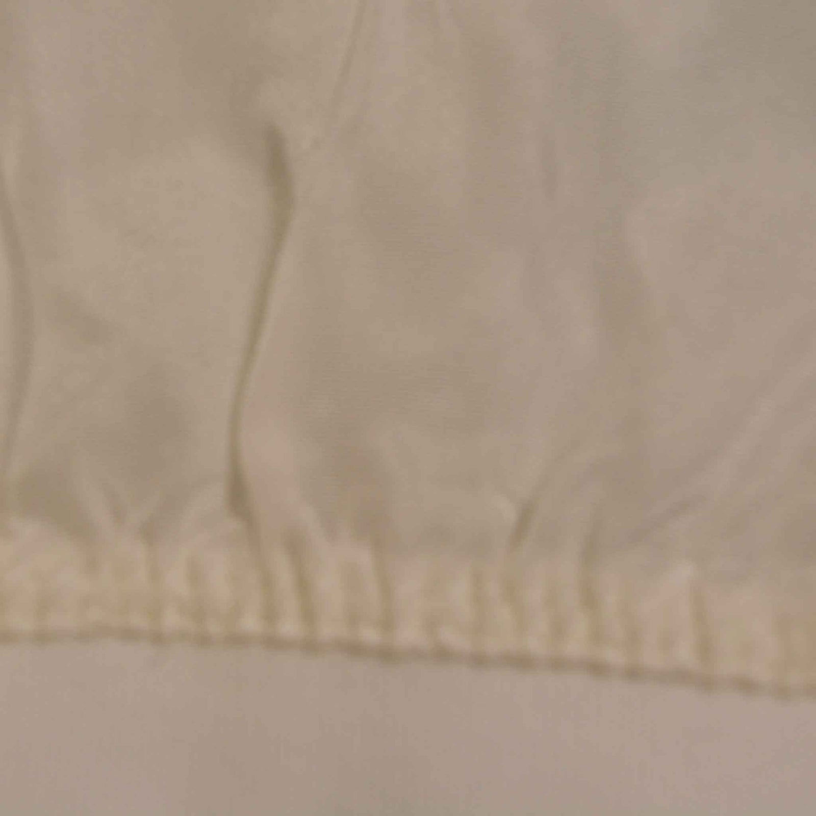 shows a close up of the raw silk glove, including the stitching to the cotton band