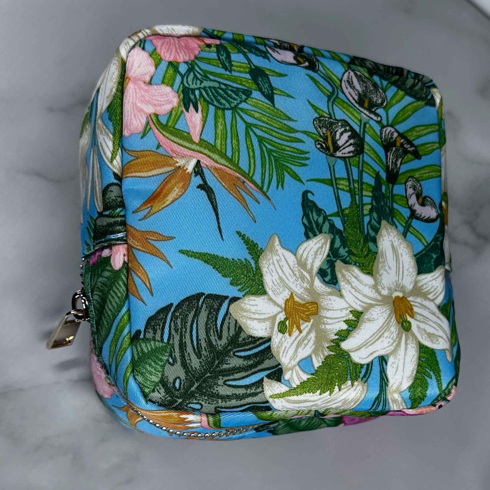 Floral and nature-themed pouch on a gray background