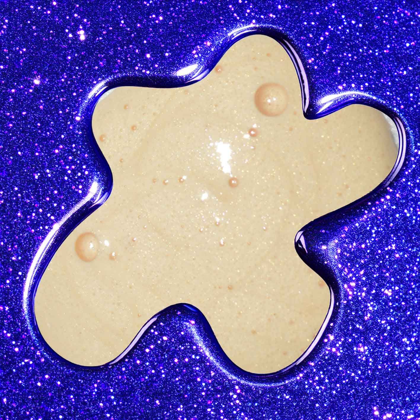 Beige flower-shaped object on a blue glittery background
