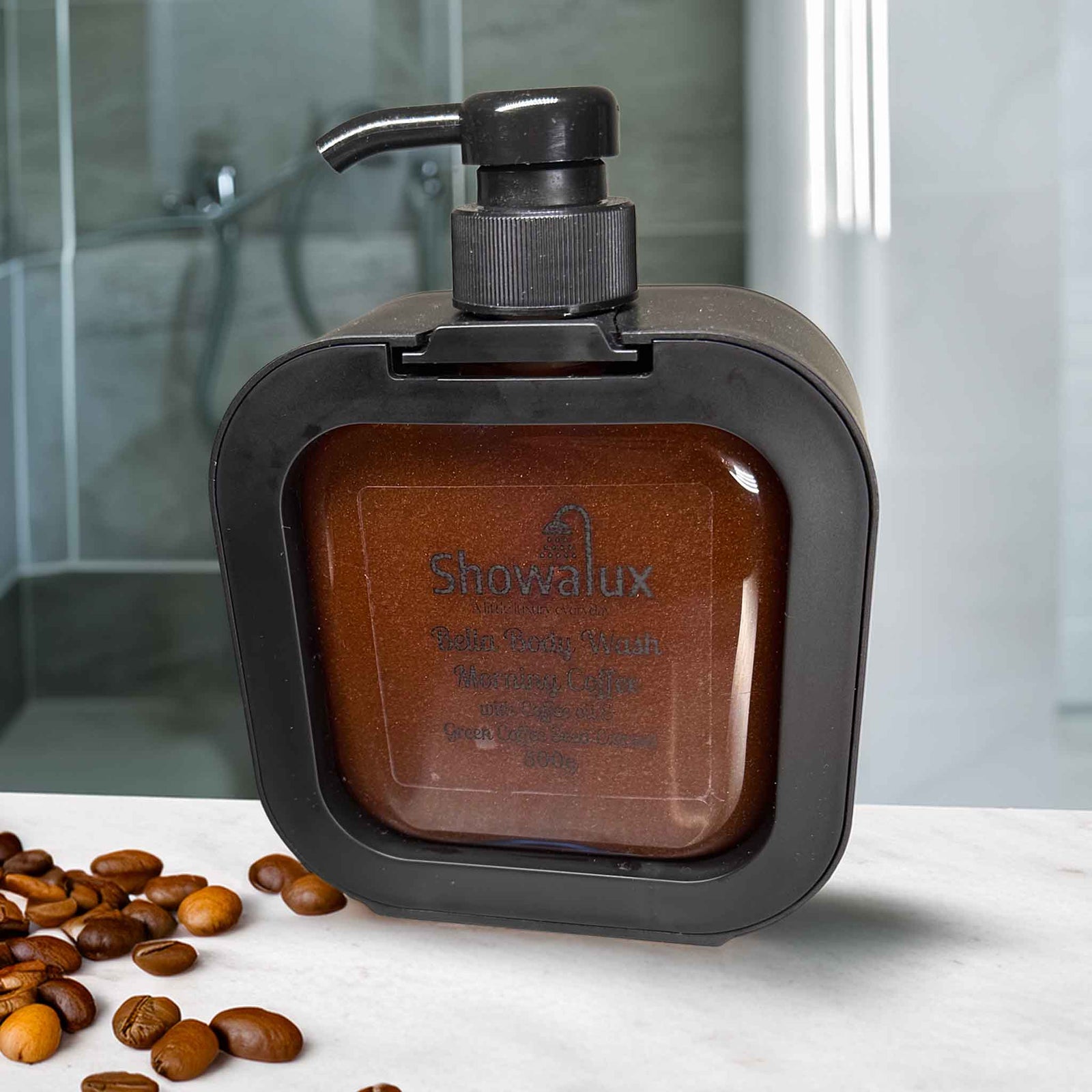 ShowaLux Bella Body Wash in a dispenser with coffee soap on a white surface with coffee beans.