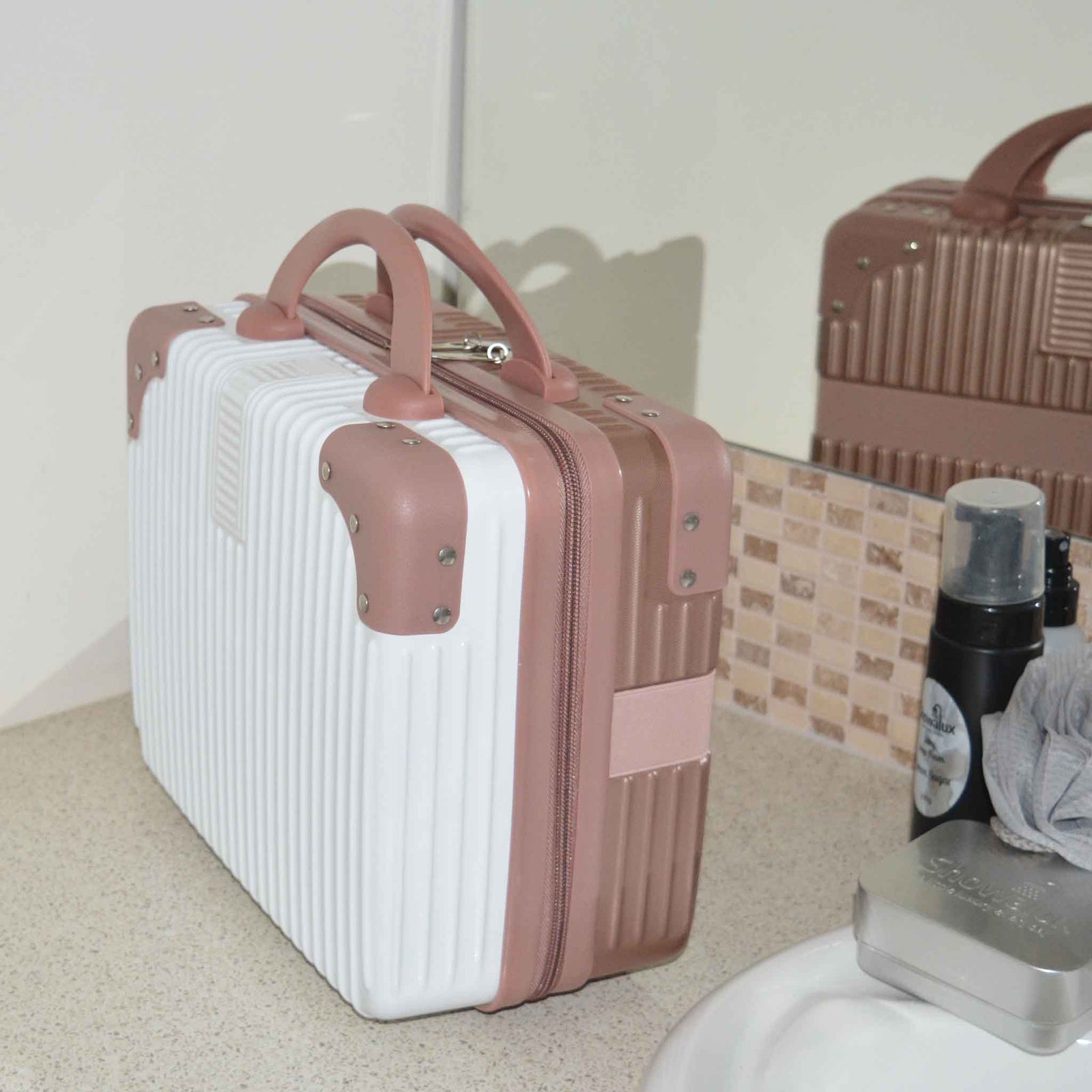 Suitcase Style Toiletry Bag closed and standing up on a bathroom bench in White and Rose Gold