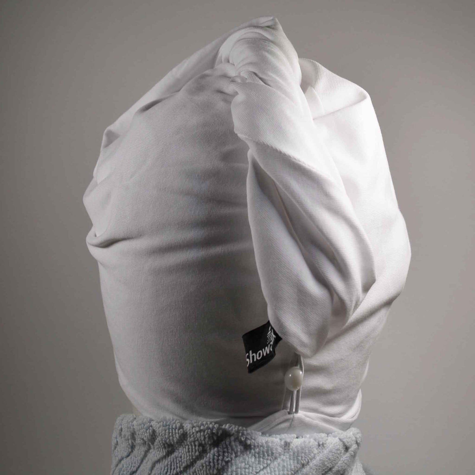 Showing wearing the white hair wrap with light blue towel round the neck on a white background