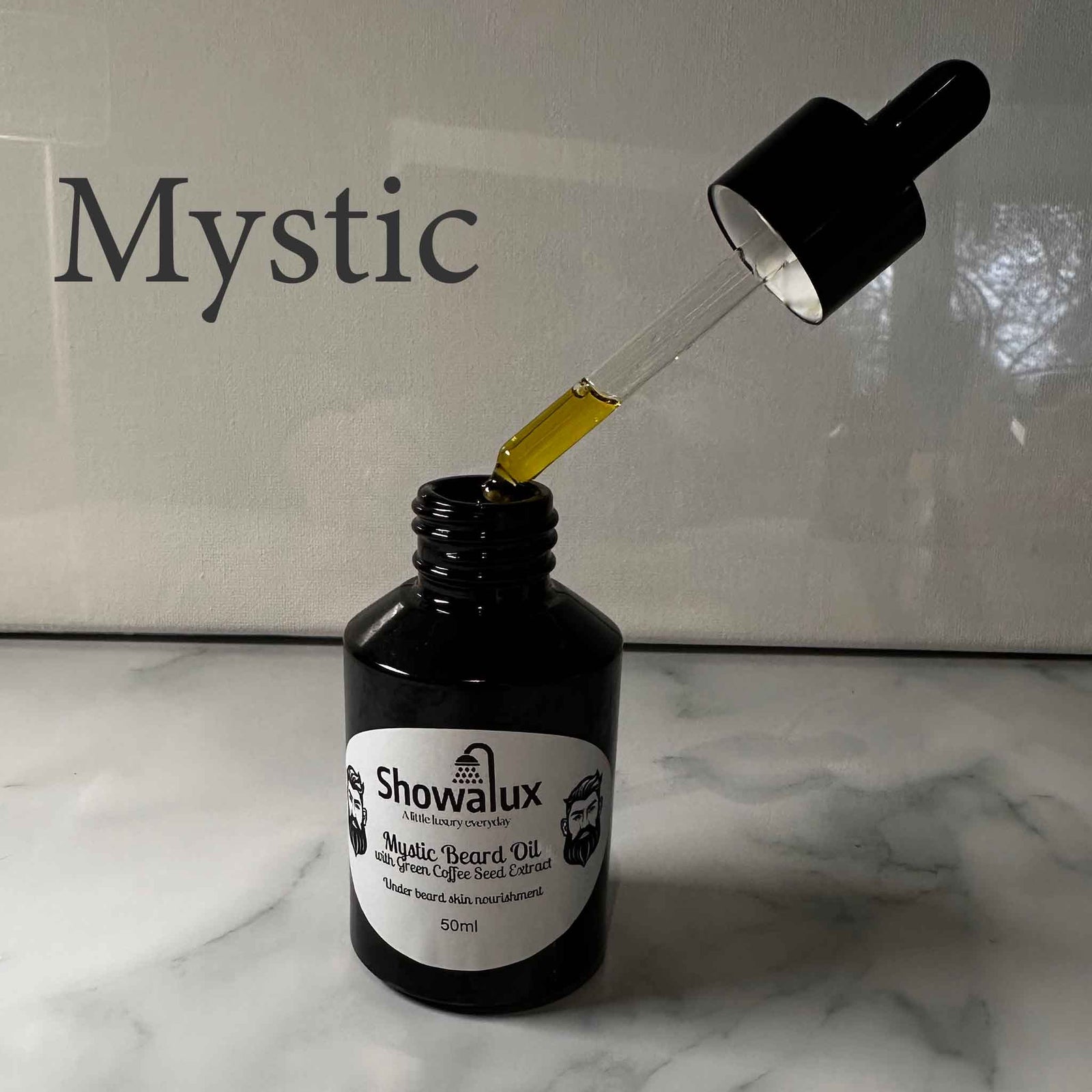A small bottle of beard oil with a silver label and an eye dropper, dripping oil into the bottle fragrance is Mystic