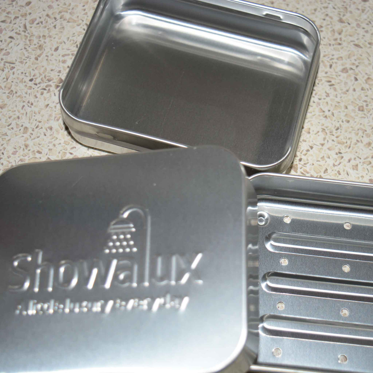 3 separate pieces of an Aluminium Soap Container.  Lid, base and insert with drainage holes