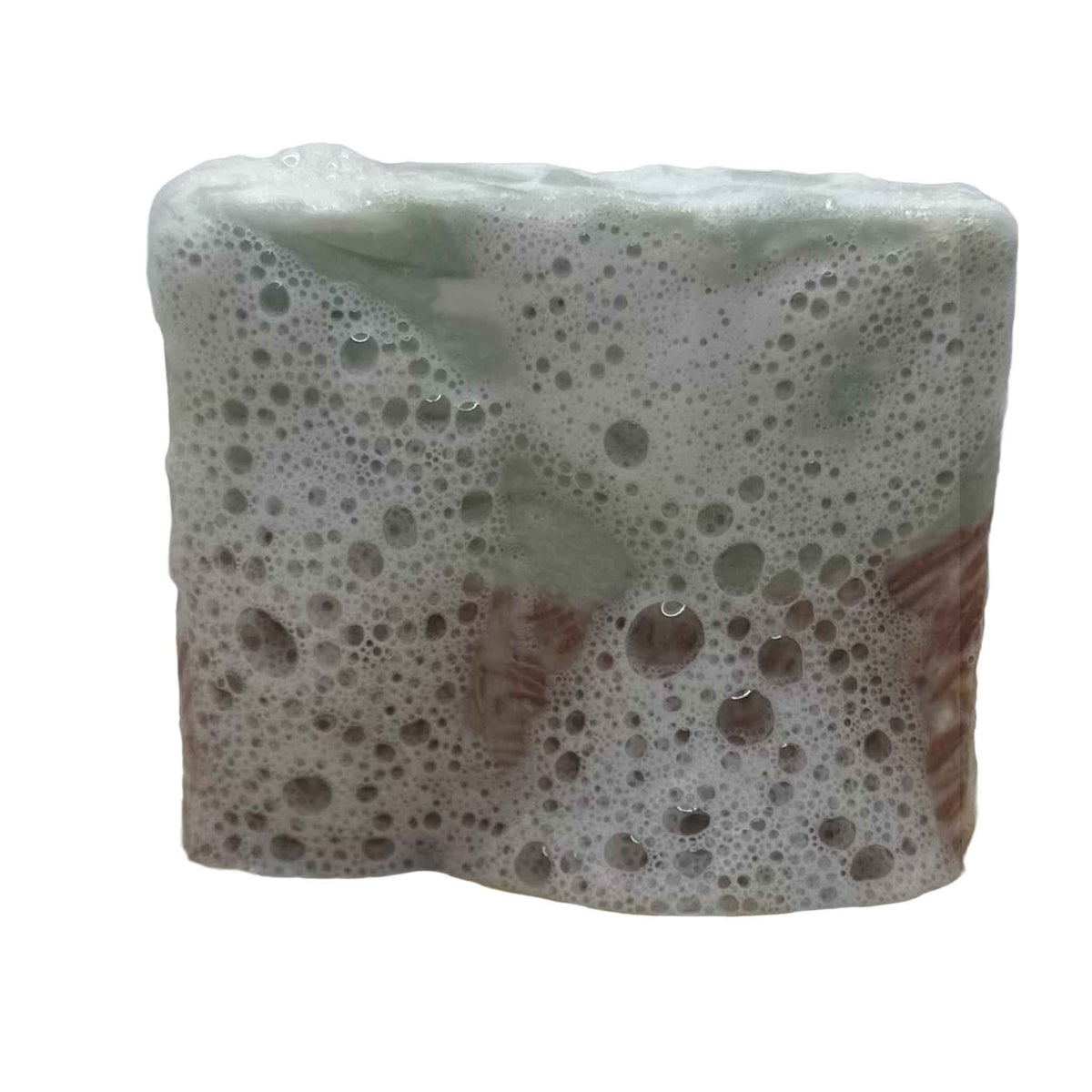 A square cake of soap half red speckled and half green speckled coated in lather