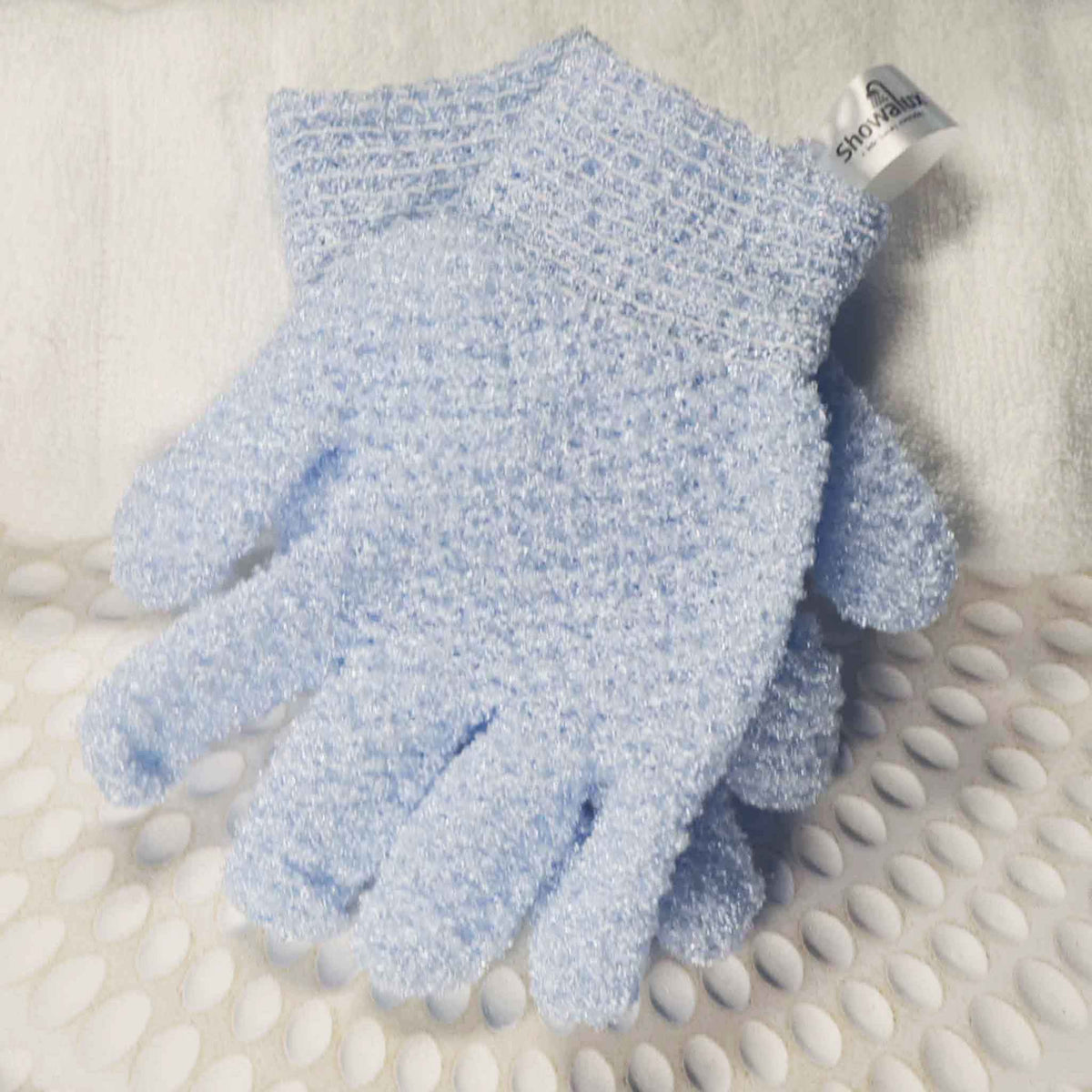 A pair of baby blue exfoliating gloves