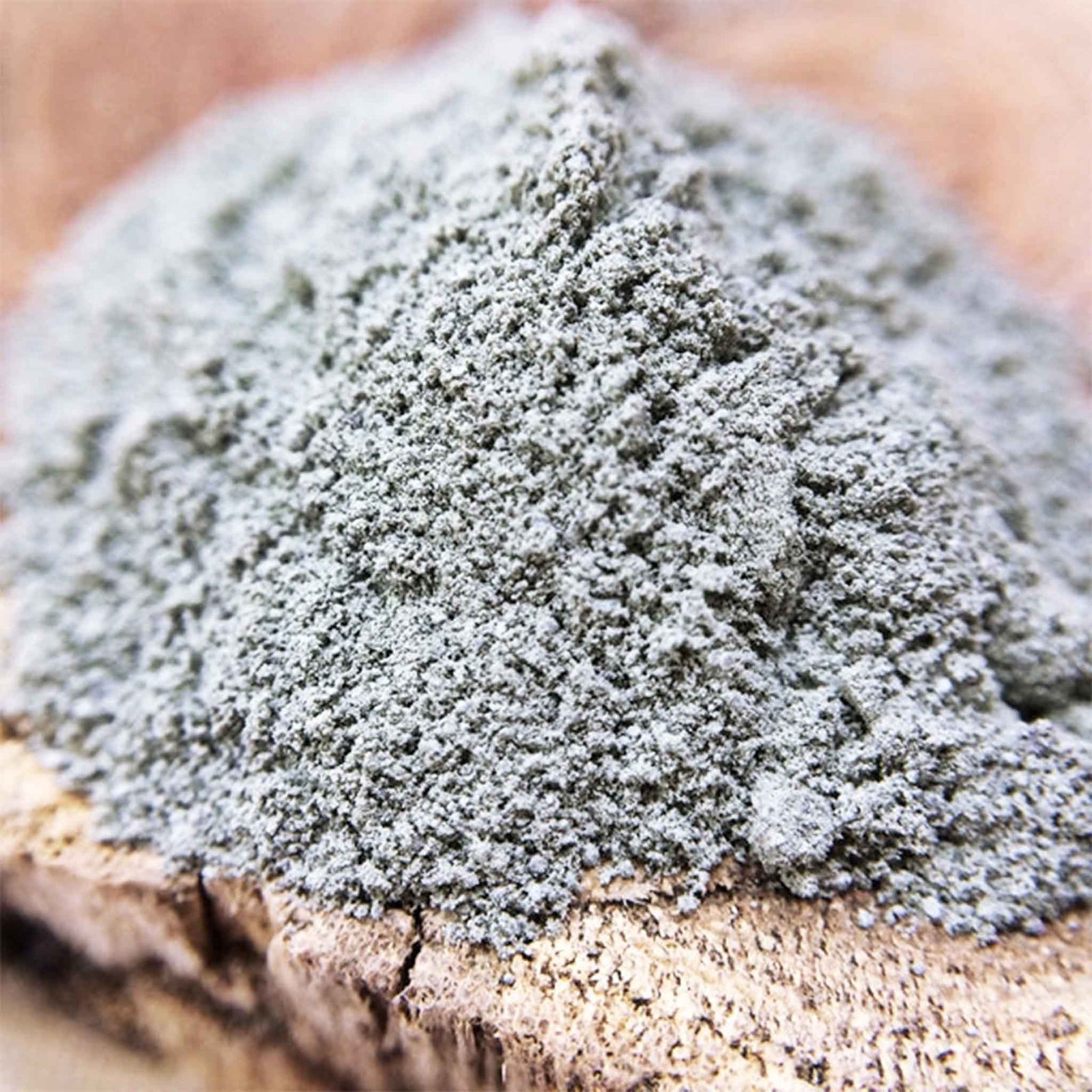 Close-up of a pile of blue clay on a wooden surface
