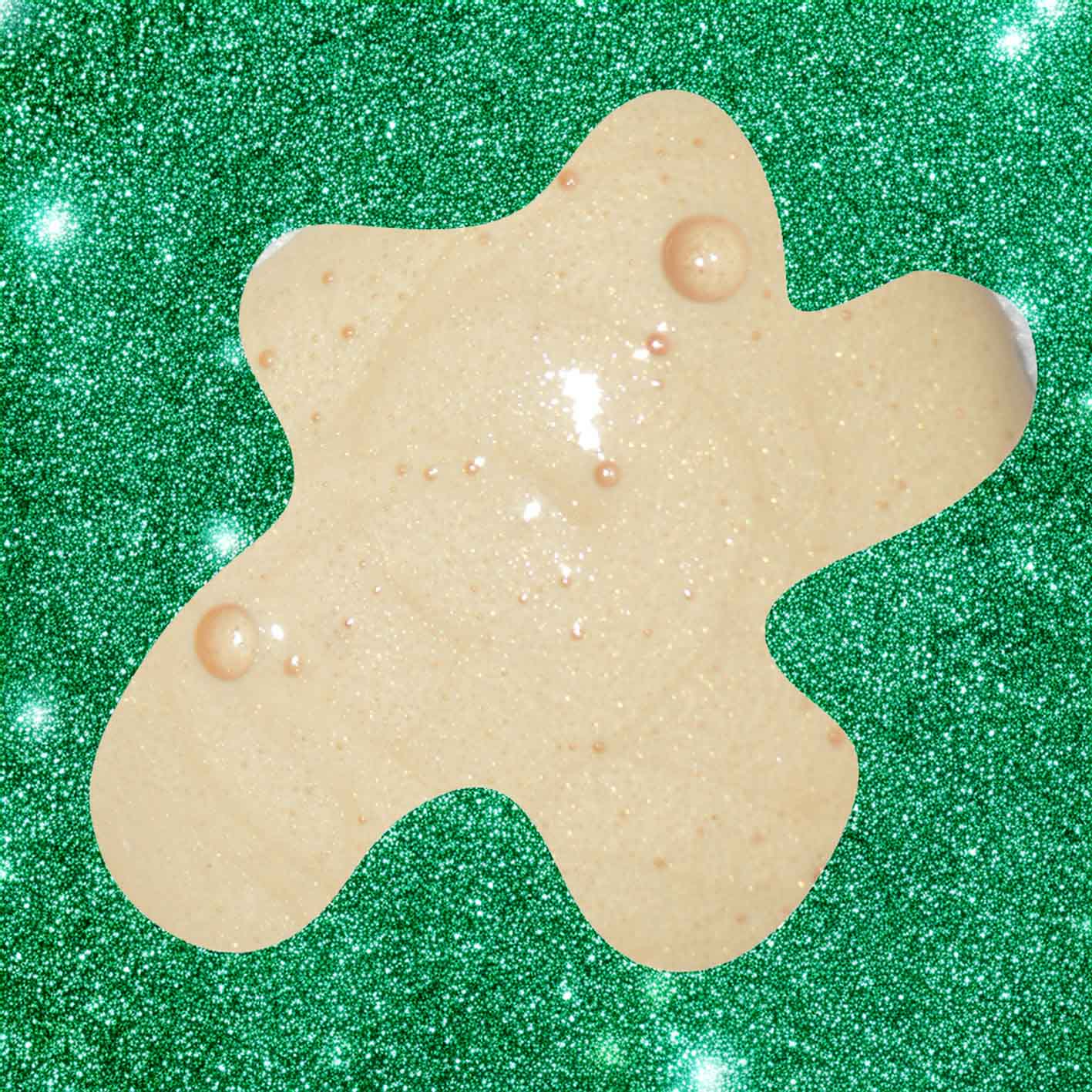 Star-shaped cream soap on a green glittery background