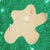 Star-shaped cream soap on a green glittery background