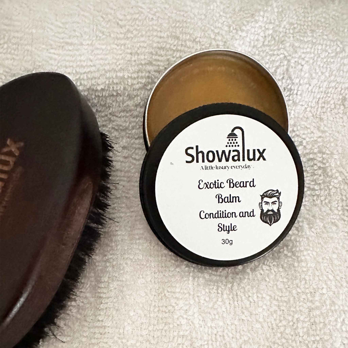 Showalux Exotic Beard Balm container with brush on a textured surface