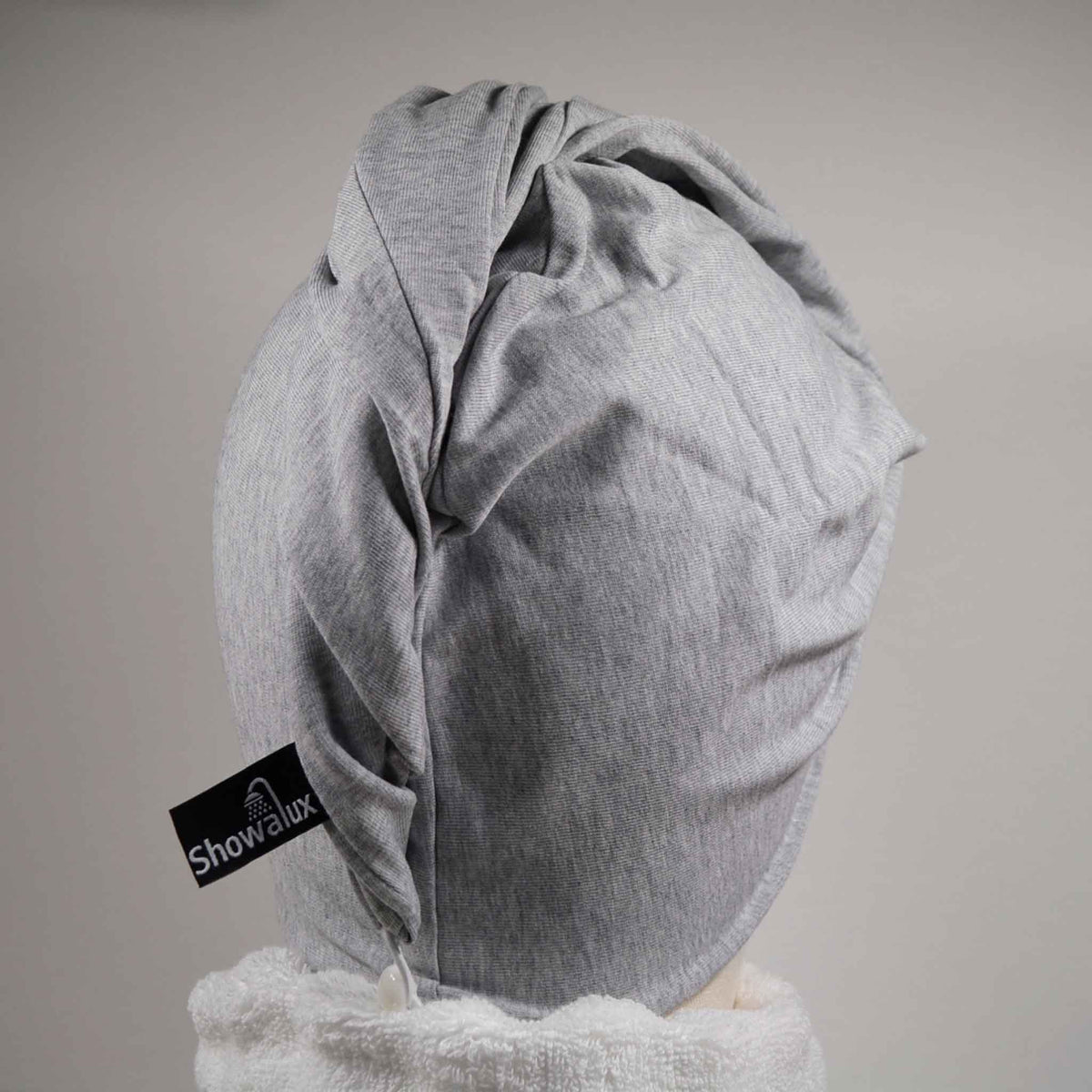Showing wearing the gray hair wrap with white towel round the neck on a white background