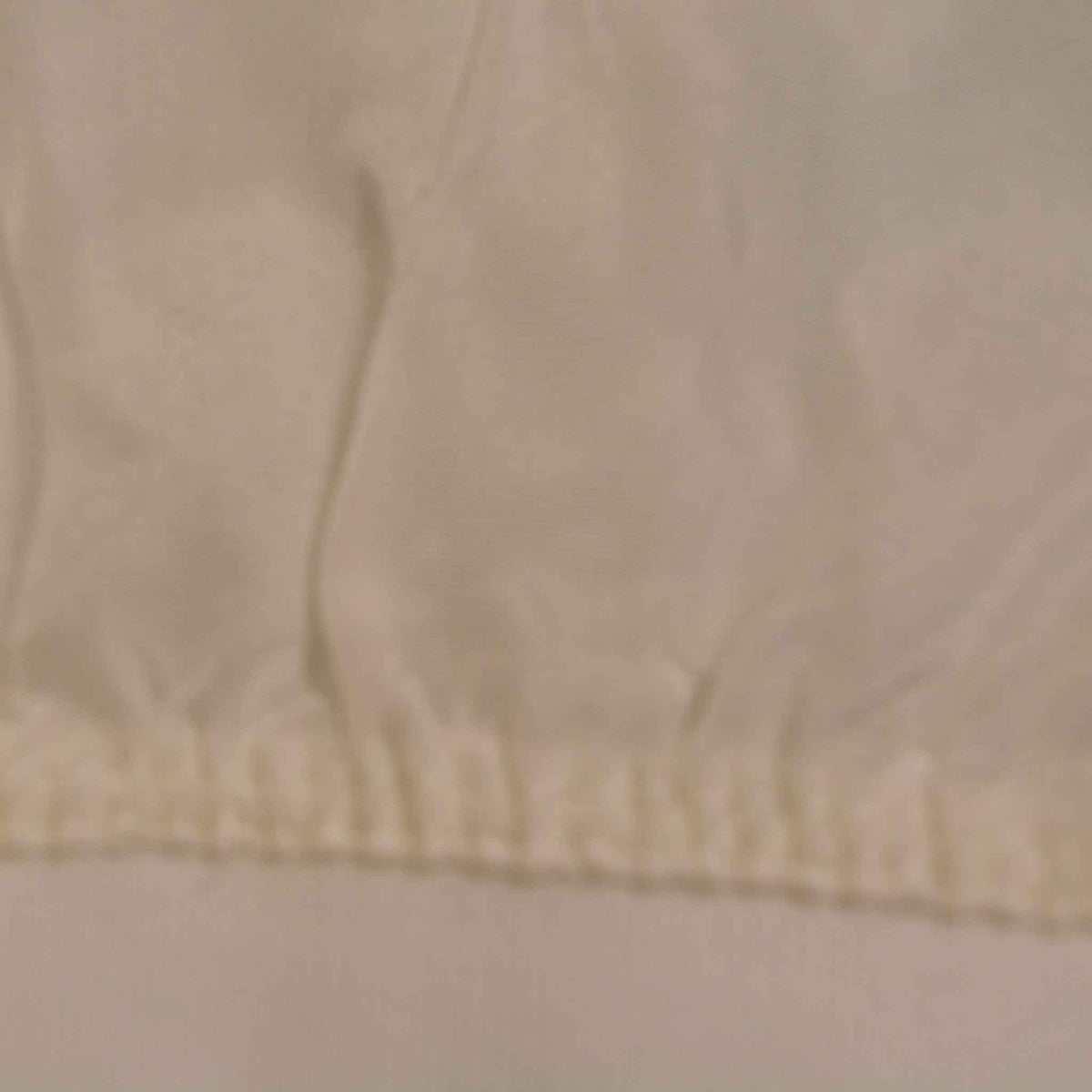 shows a close up of the raw silk glove, including the stitching to the cotton band