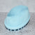 Light Blue soft silicone scrub brush with very soft fine bristles on one side, and short firm nubs on the other side