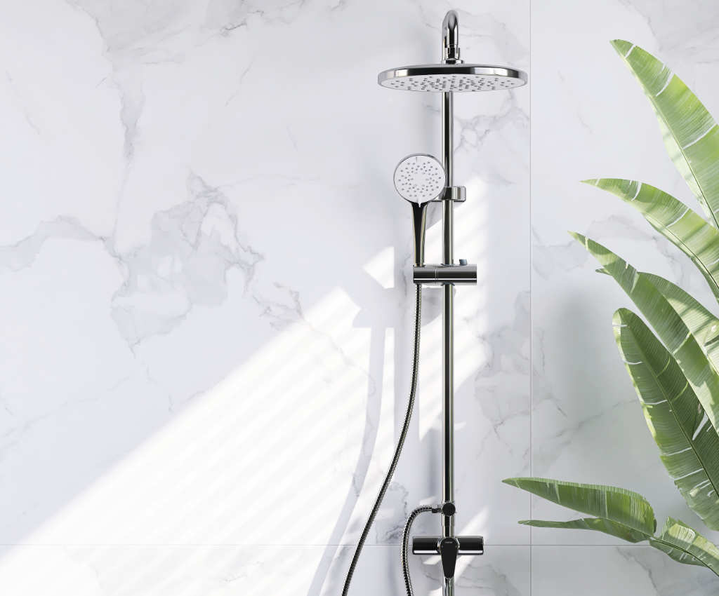 Chrome shower head and hose against a marble wall with a plant in the corner