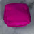 Hot Pink Showalux personal bag with a zipper on a marble surface