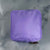 Purple Showalux personal bag with a gold zipper on a marble surface