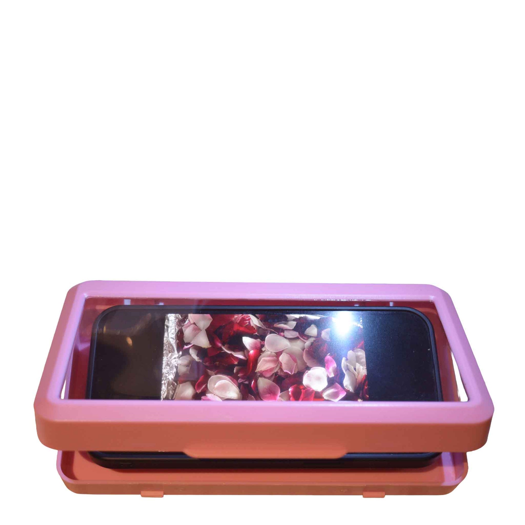 White Phone holder on tiled wall with phone inside showing bright pink pictures