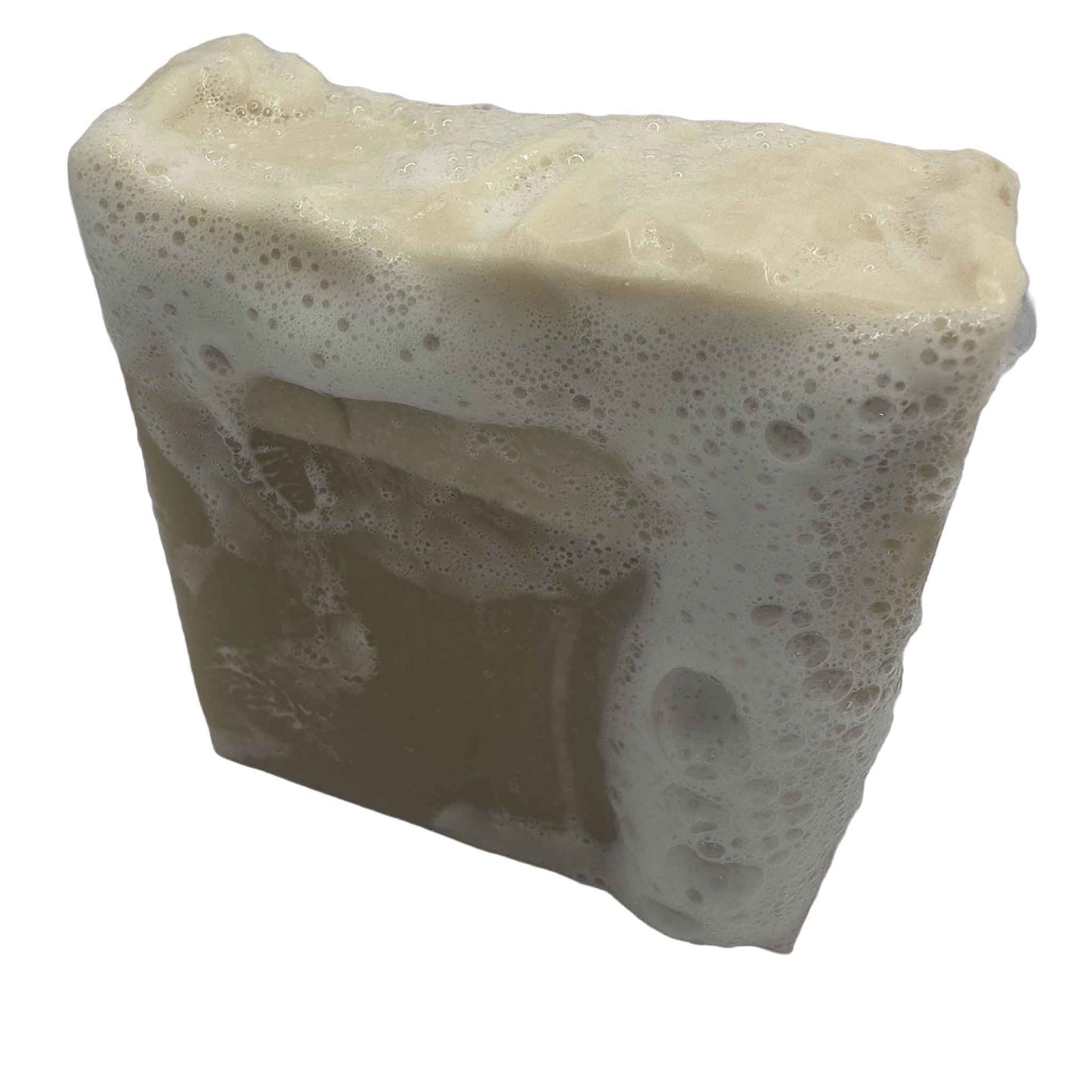 A square bar of soap that is white on top and natural colour on the bottom 2/3s on a tiled bathroom bench