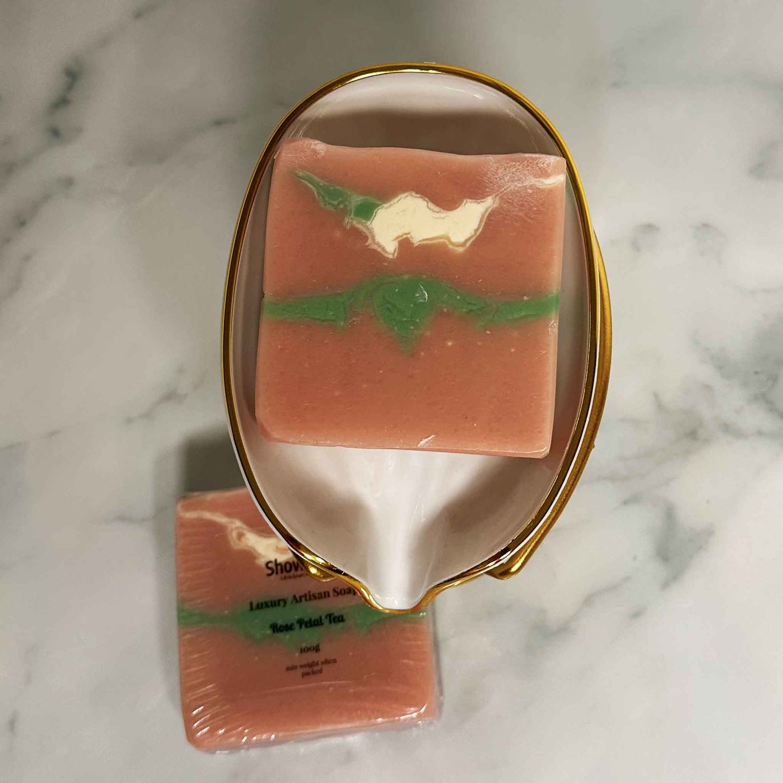 Two bars of Showlux soap on a marble surface