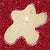 Star-shaped cream soap on a red glittery background