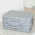 Suitcase Style Toiletry Bag closed and laying on its side on a bathroom bench in Silver