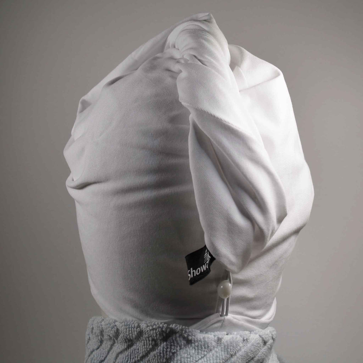 Showing wearing the white hair wrap with light blue towel round the neck on a white background