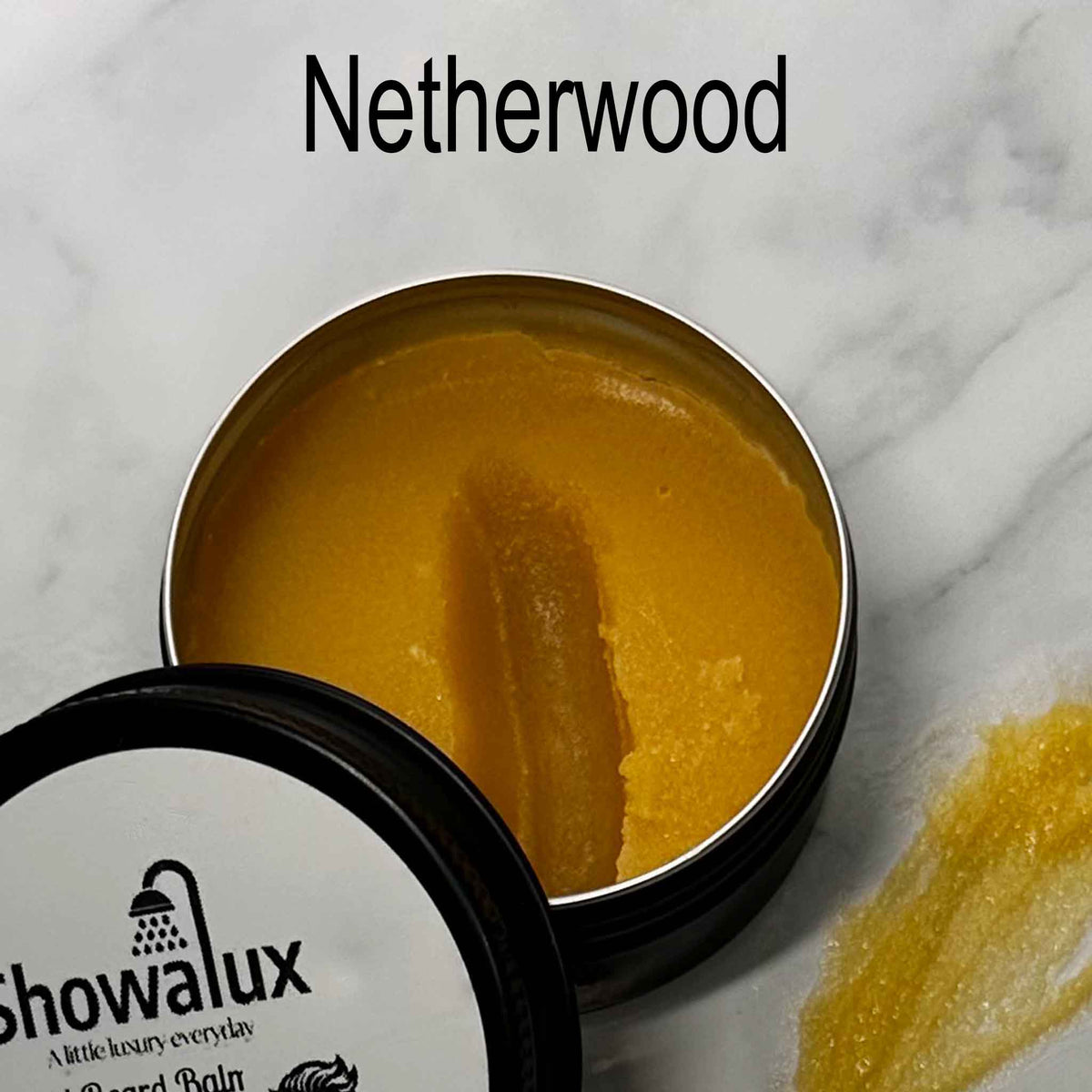Showalux beard balm in a tin with 'Netherwood' branding on a marble surface