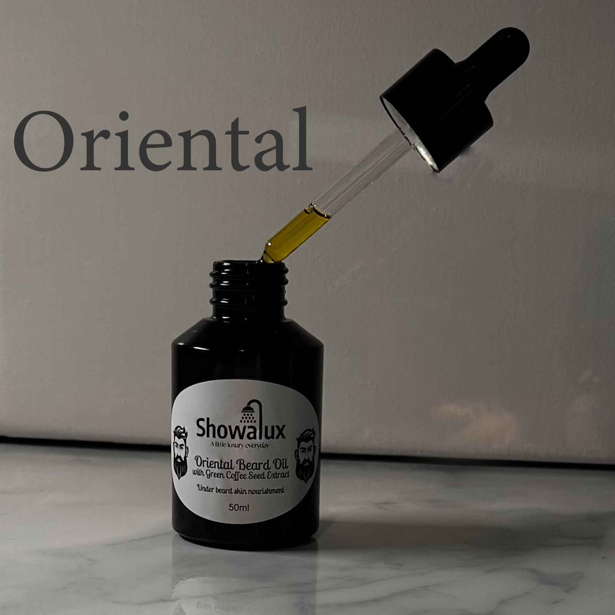 A small bottle of beard oil with a silver label and an eye dropper, dripping oil into the bottle fragrance is Oriental