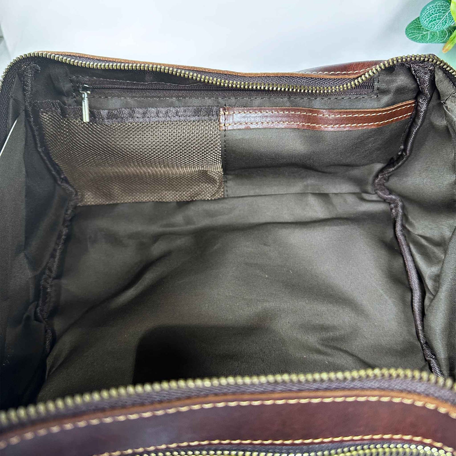 Open bag showing interior with zippers and mesh pocket.