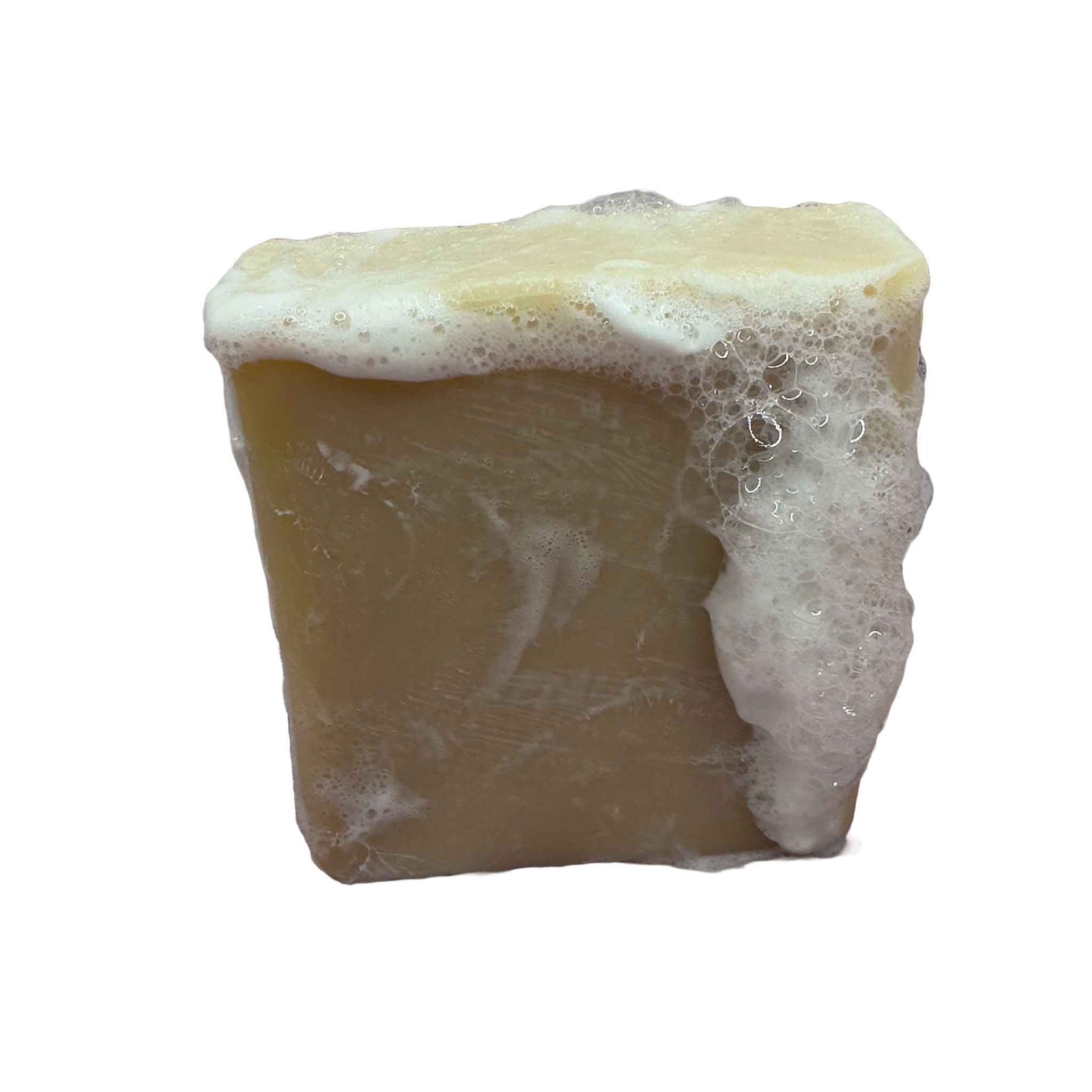 A natural soap, cream coloured on a wood bench with a tiled background