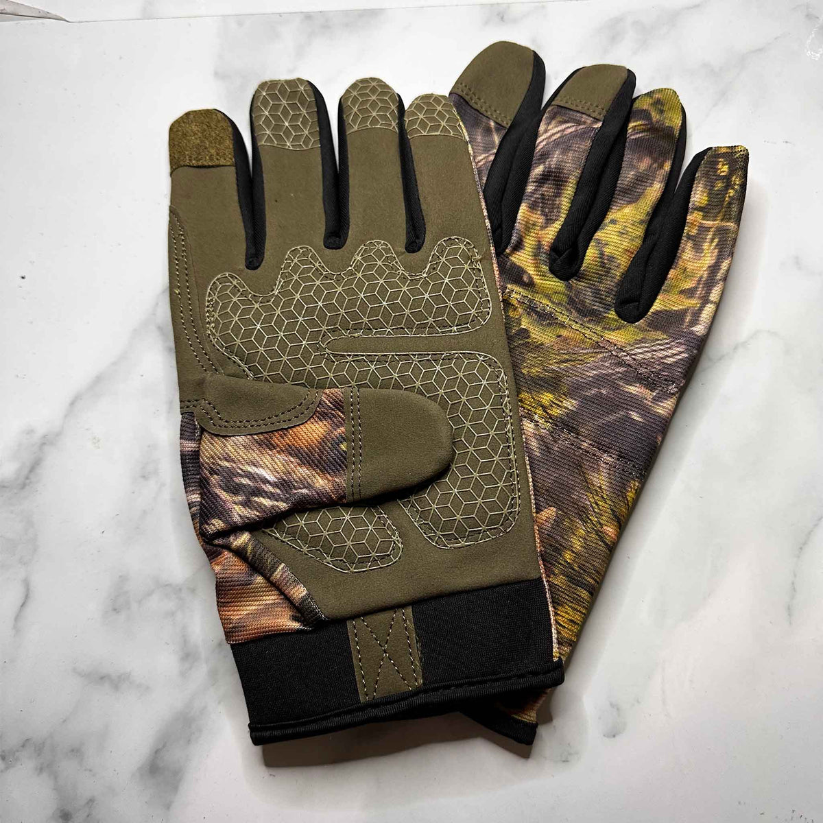 Camouflage gloves on a marble surface