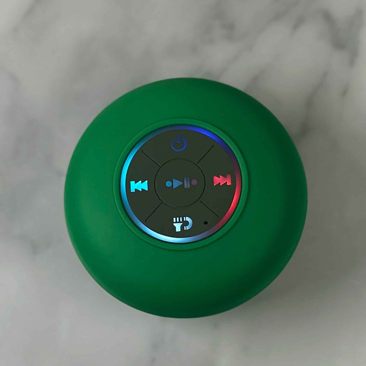 Showalux Green Speaker with colorful buttons on a marble background