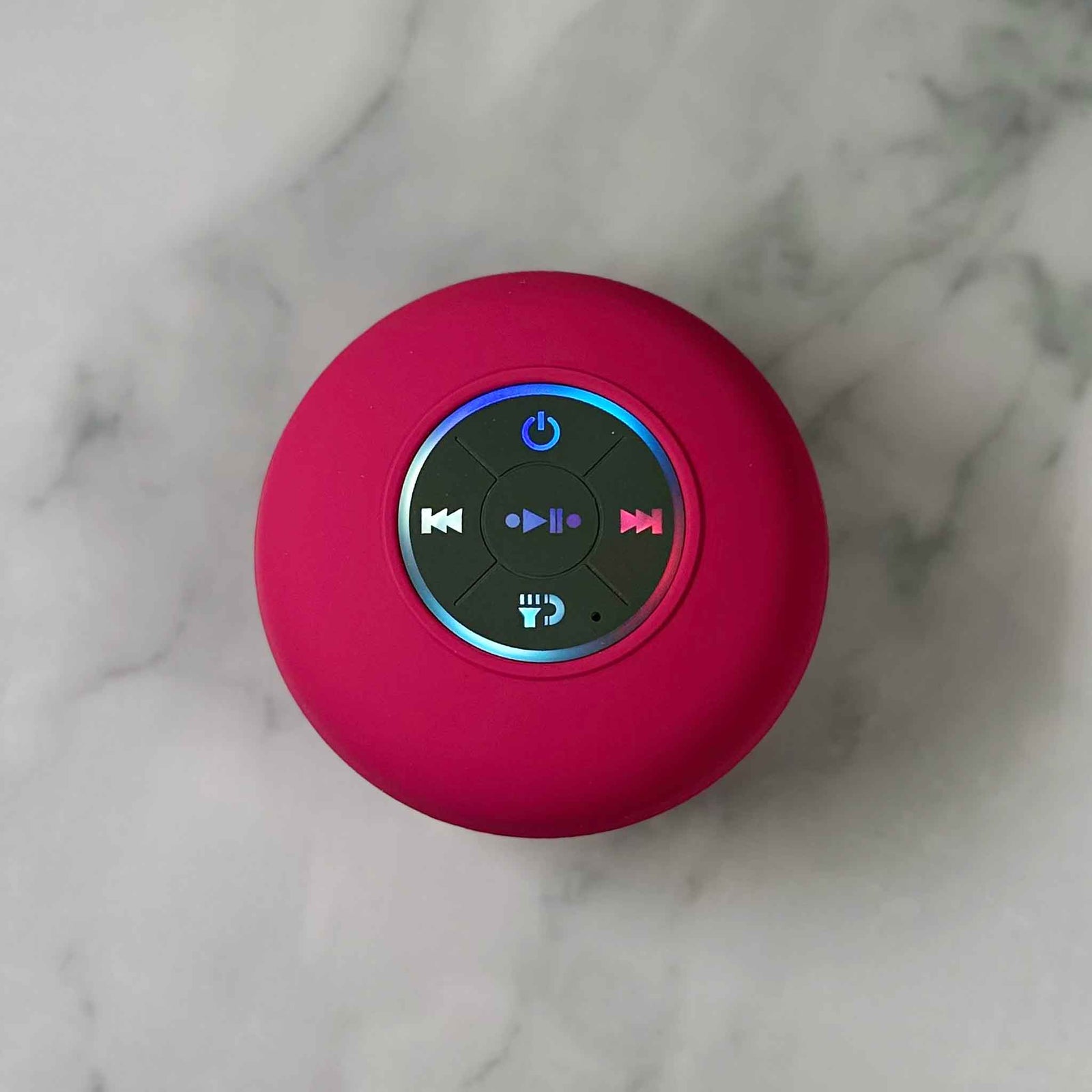Showalux Pink Speaker with colorful buttons on a marble background