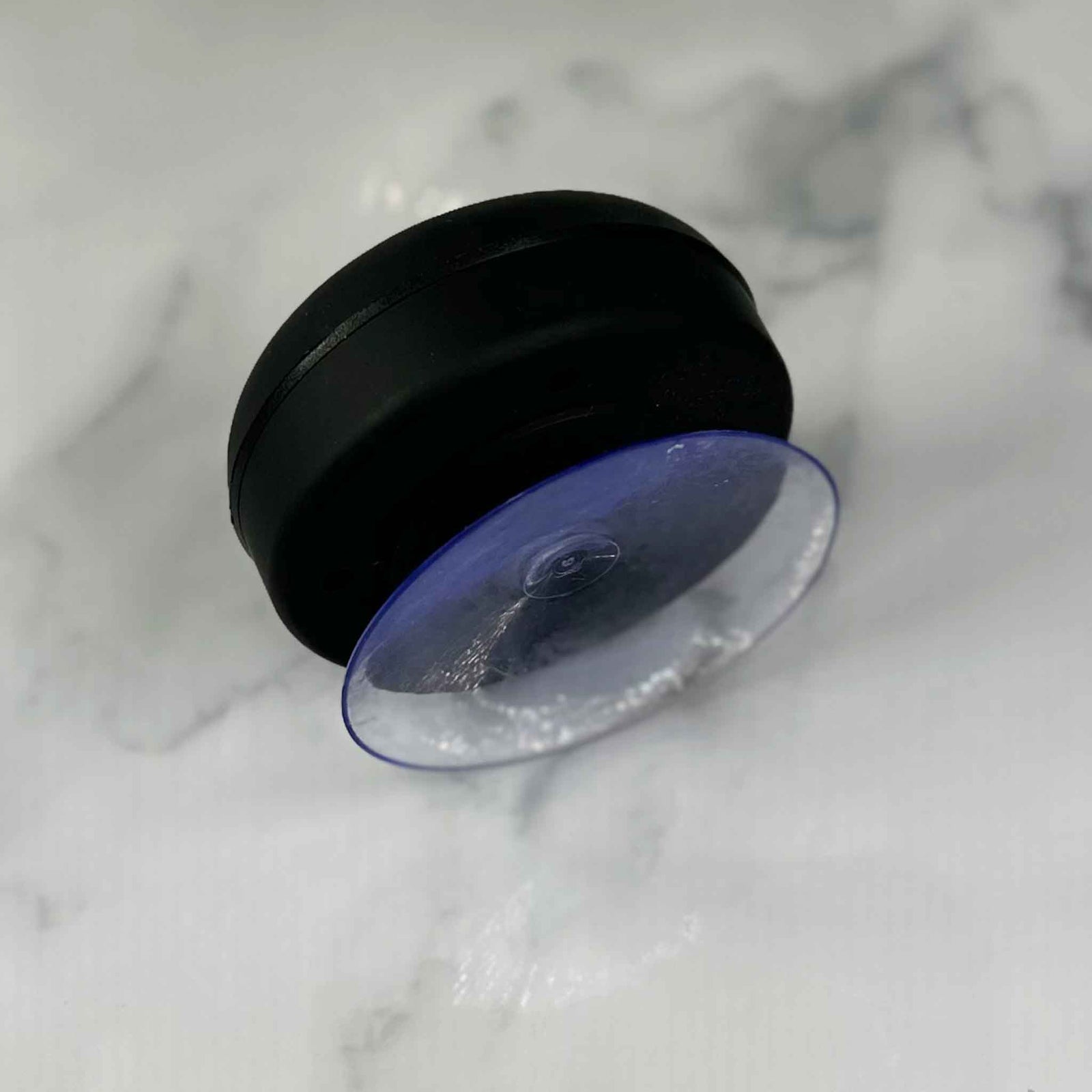 Showalux Black speaker suction cap on a marble surface