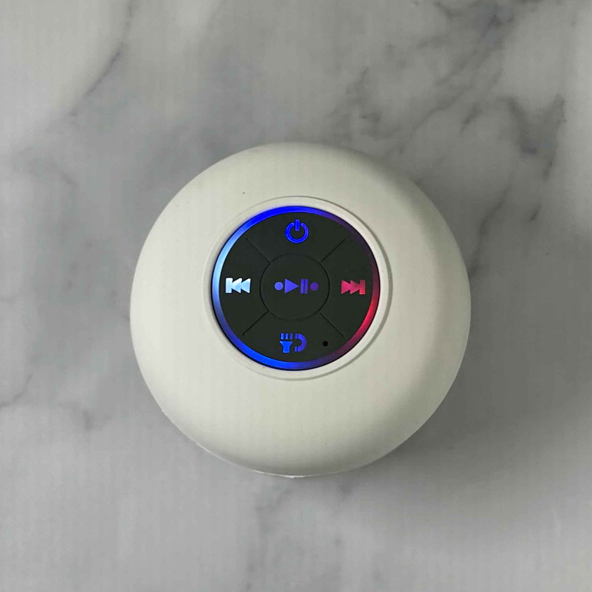 Showalux White Speaker with colorful buttons on a marble background