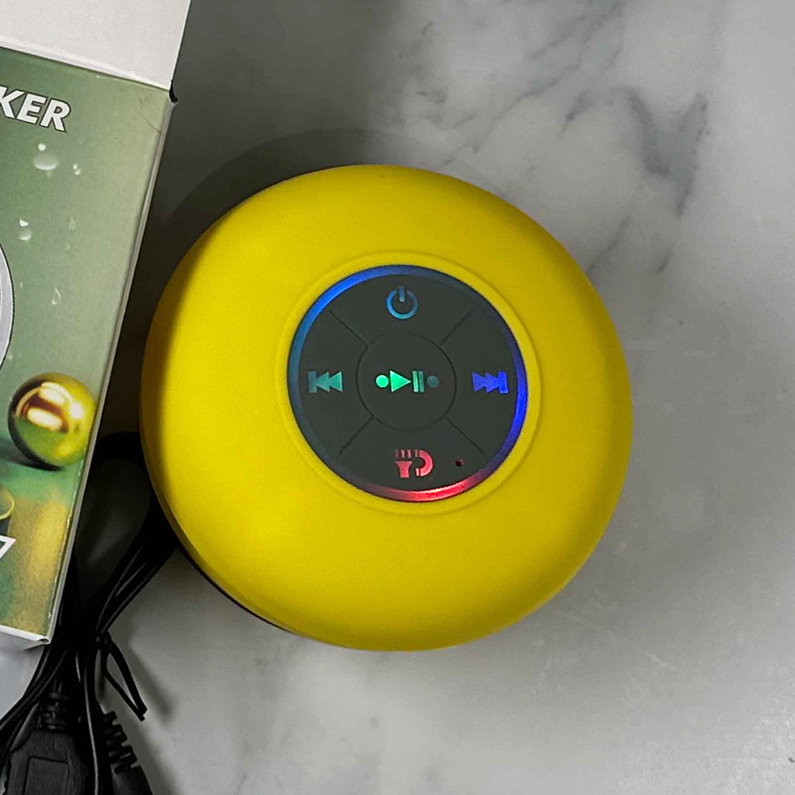 Showalux yellow Speaker with colorful buttons on a marble background